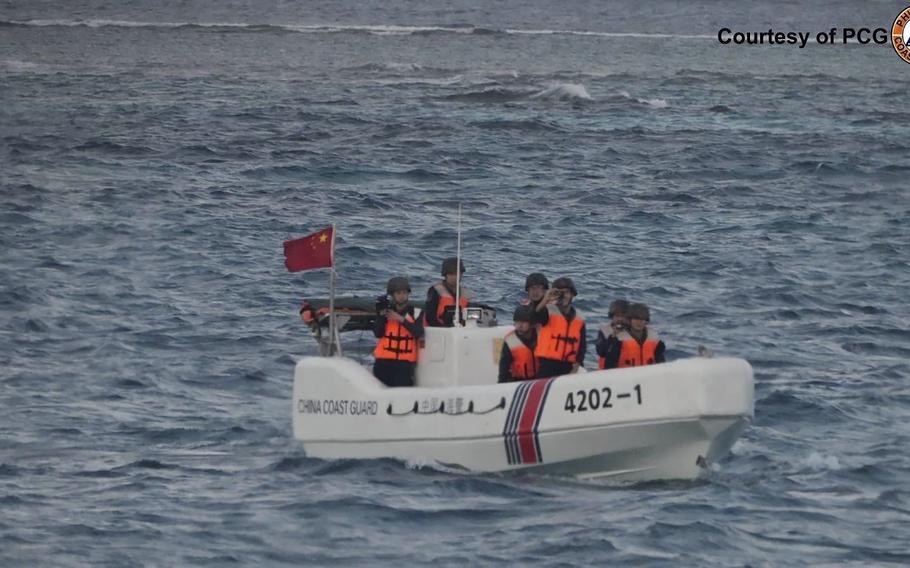 A boat with men floats in the sea.