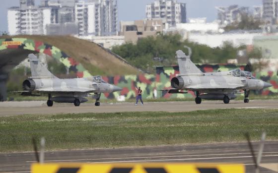 Fighter jets take off from an airbase.