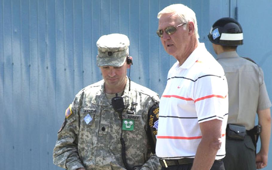 Basketball legend Jerry West talks with a United Nations Military Armistice Commission escort during a visit Thursday to the Joint Security Area of Korea’s Demilitarized Zone. West, whose brother David was killed in the Korean War, said his visit to South Korea was probably the highlight of his life.