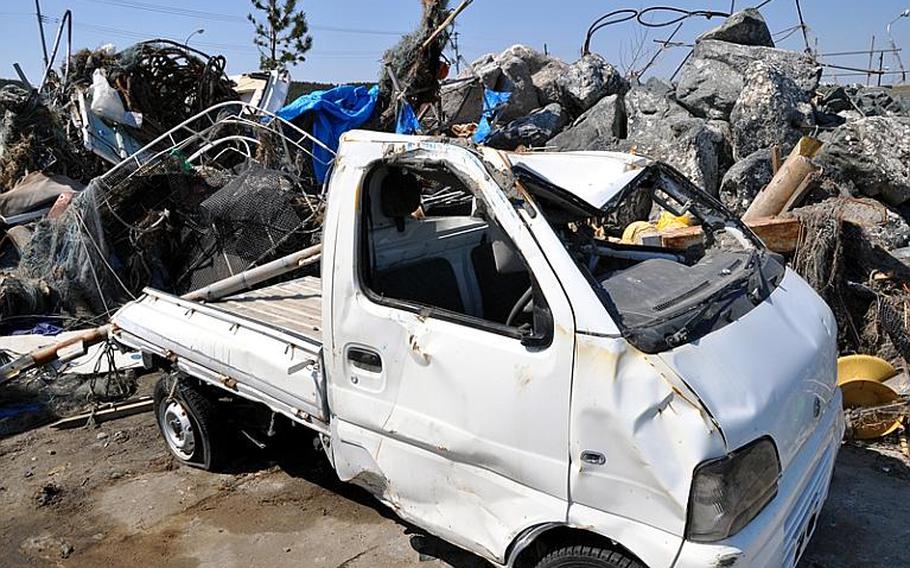 A smashed truck and other debris sit along the waterfront at Misawa City's fishing port earlier this month. Officials say a giant tsunami wave gutted the port, killing two and injuring one on March 11 following the massive earthquake that rocked the region.