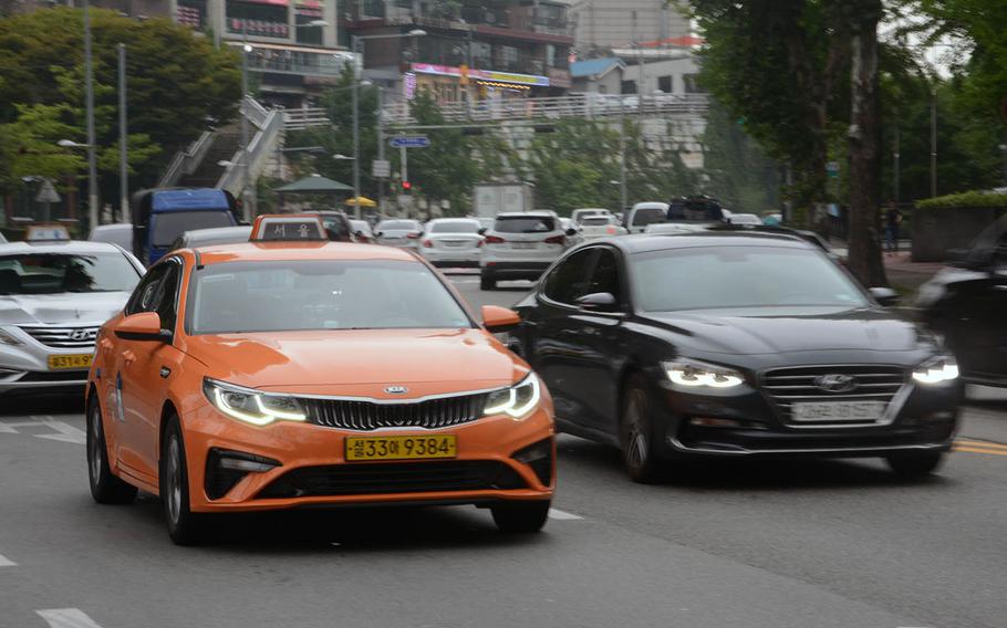 A taxi makes its way along the streets near Itaewon, in Seoul, South Korea, on Thursday, July 25, 2019.