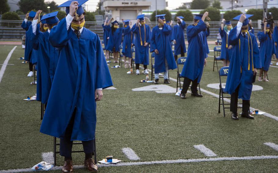 Yokota High School seniors move their tassels during a graduation ceremony at Yokota Air Base, Japan, Thursday, June 4, 2020.