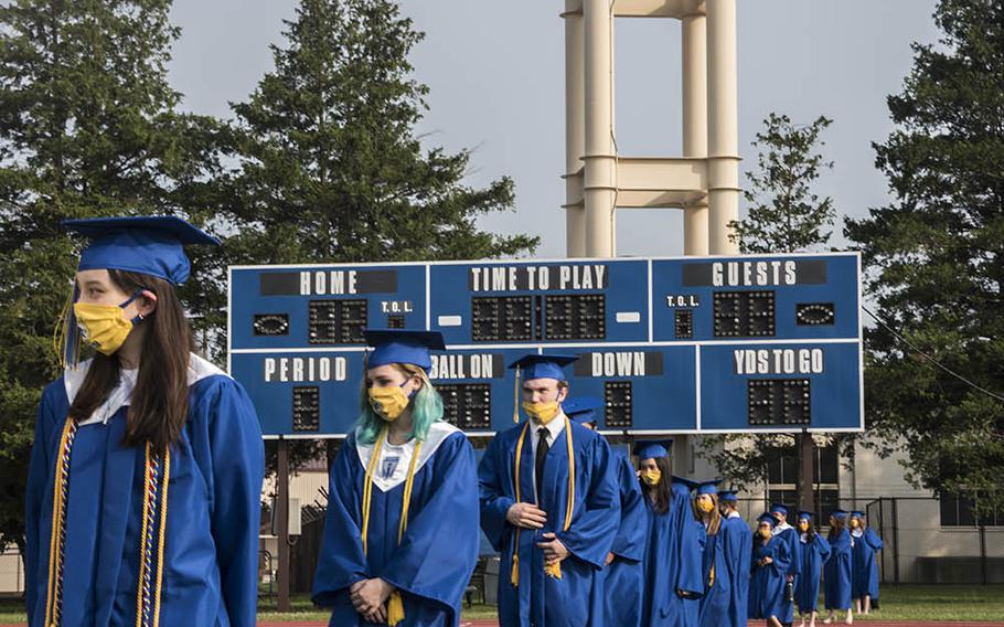 Seniors from Yokota High School take the field for their graduation ceremony at Yokota Air Base in western Tokyo, Thursday, June 4, 2020.