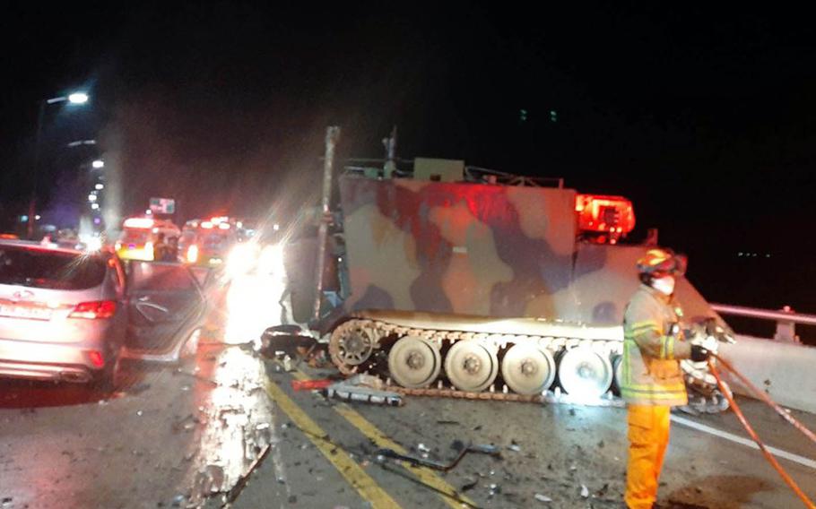 Emergency workers tend to the scene after a collision involving a U.S. armored personnel carrier and a civilian SUV that killed four South Koreans near the Rodriguez Live-Fire Complex in Pocheon, South Korea, Aug. 30, 2020.