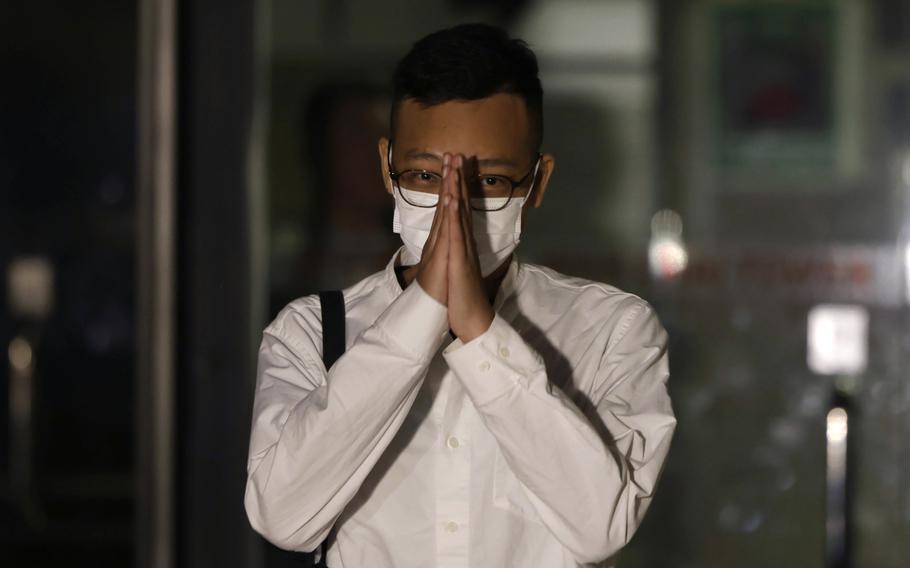 Patrick Lam, the former acting editor-in-chief of Hong Kong's now shuttered pro-democracy news outlet Stand News gestures to the gathered media as he leaves the Wanchai District Court after the final sentencing of Stand News sedition case in Wan Chai district court in Hong Kong on Thursday, Sept. 26, 2024. 