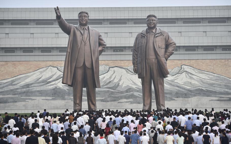 People visit the statues of the late North Korean leaders Kim Il Sung and Kim Jong Il on the 29th anniversary of Kim Il Sung's death, at Mansu Hill on July 8, 2023, in Pyongyang. 