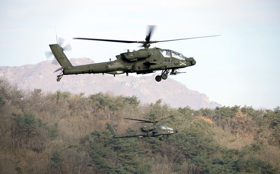 Apaches hover over the Rodriguez Live Fire Complex in South Korea.