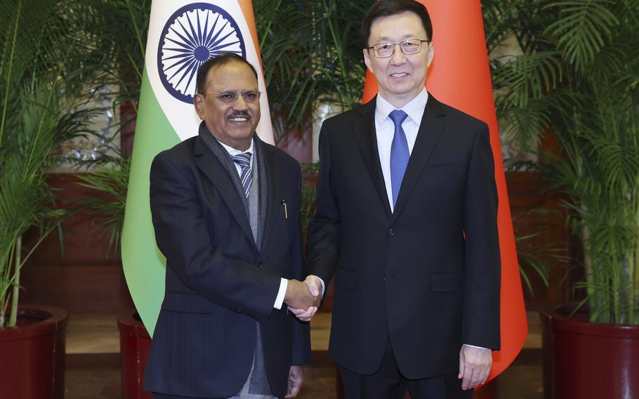 Chinese Vice President and Indian National Security Advisor pose for a photo.