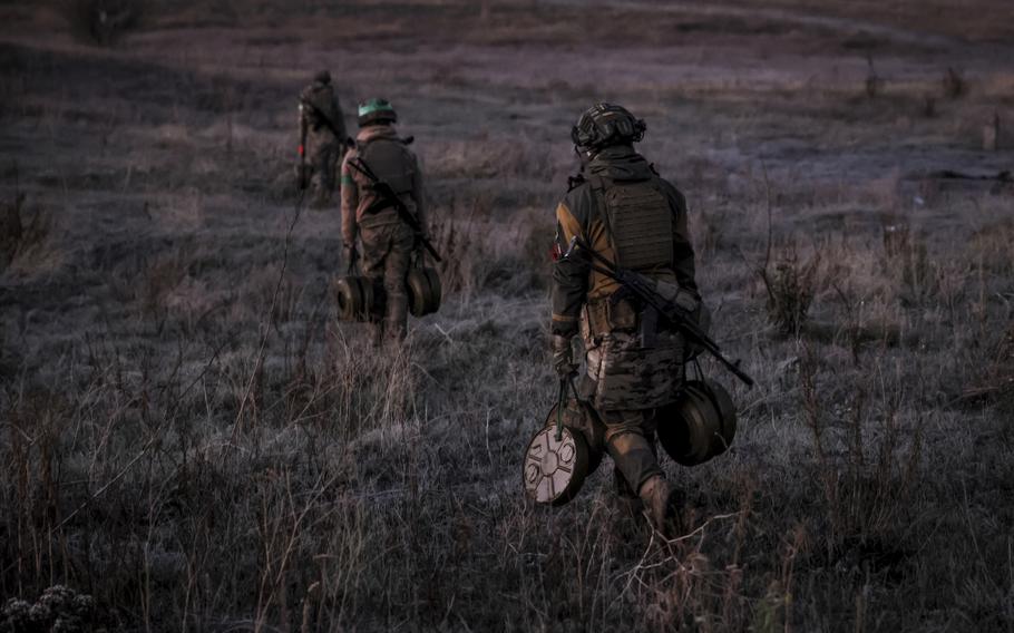 Ukrainian servicemen of the 24th Mechanised Brigade install anti-tank landmines and non explosive obstacles along the front line near Chasiv Yar town in Donetsk region, Ukraine, on Oct. 30, 2024. 