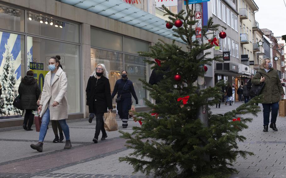 Shoppers walk in downtown Kaiserslautern, Germany, on Dec. 14, 2020, two days before tougher coronavirus restrictions are implemented in Germany. 

