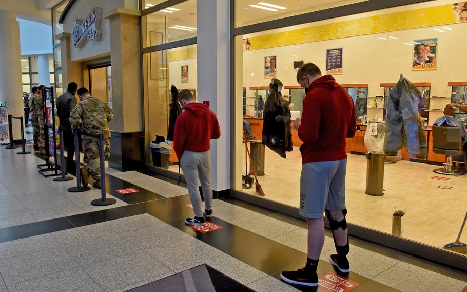 A line formsoutside the barbershop at the Kaiserslautern Military Community Center on Ramstein Air Base, Germany, on Tuesday, Dec. 15, 2020, a day before strict new coronavirus measures were to go in effect in Germany. Hairdressers are among non-essential businesses set to close until at last Jan. 10 under the new rules.
