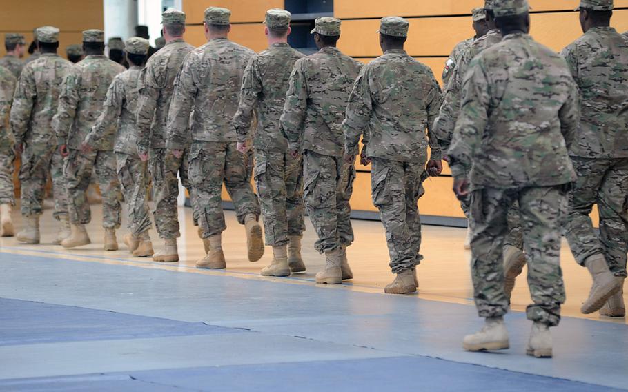 Soldiers of V Corps march out of the Wiesbaden Army Airfield fitness center following a casing of the colors ceremony for the corps on Thursday. The corps is headed for an Afghanistan deployment and is leaving Germany for good after more than 60 years.