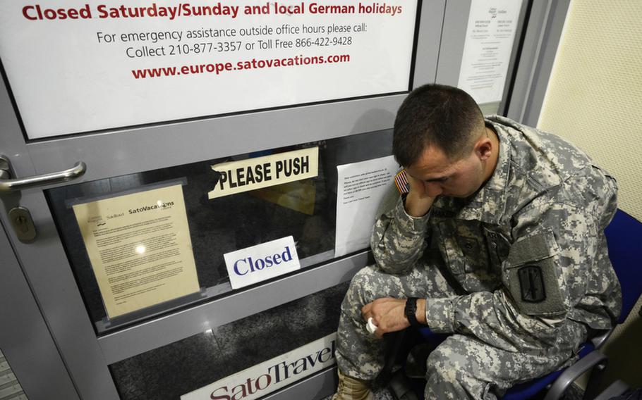 U.S. Army Pfc. Alec Hakes, an infantryman with the 170th Infantry Brigade combat Team, waits outside the scheduled airlines ticket office on Smith Barracks, Baumholder, Germany, to get travel arrangements as the 170th is scheduled to inactivate later this fall. Hakes waited outside SATO from 11:30 the night before to get a good spot in line.