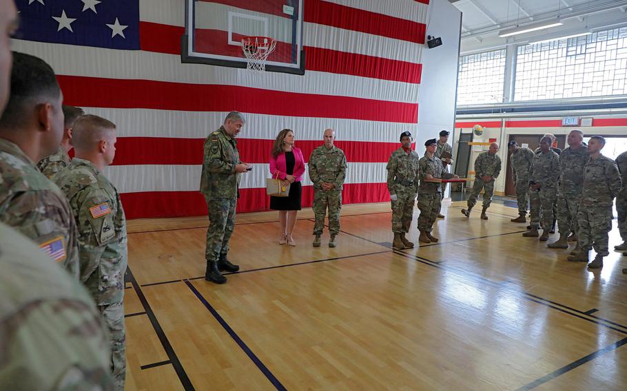 U.S. Army Col. David Shank, center right, receives the German armed forces Silver Cross of Honor from German Brig. Gen. Michael Hogrebe, center left, before the 10th Army Air and Missile Defense Command change of command ceremony at Kleber Kaserne gym, Aug. 7, 2019.   Christopher Dennis/Stars and Stripes