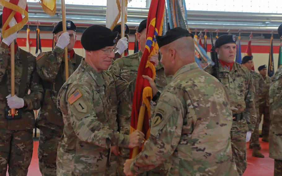 Brig. Gen. Gregory Brady receives the 10th Army Air and Missile Defense Command colors from Lt. Gen. Christopher Cavoli, U.S. Army Europe commander, during the change of command ceremony held at the Kleber Kaserne in Kaiserslautern, Germany, Aug. 7, 2019.