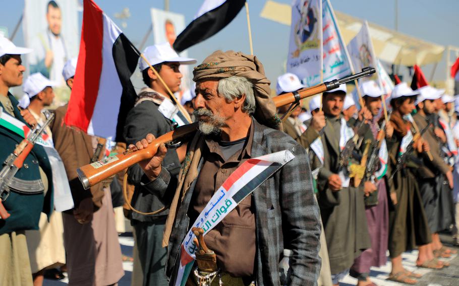 A Yemeni man carries a rifle as he takes part in march to express solidarity with the people of Gaza, in the Huthi-controlled capital Sanaa on Dec. 2, 2023. Israel and Hamas brushed off international calls to renew an expired truce on Dec. 2 as air strikes pounded militant targets in Gaza and Palestinian groups launched volleys of rockets. 
