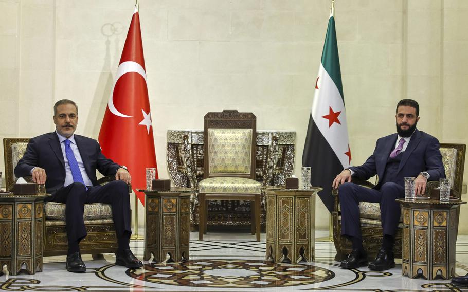 Two men in a meeting in Syria.