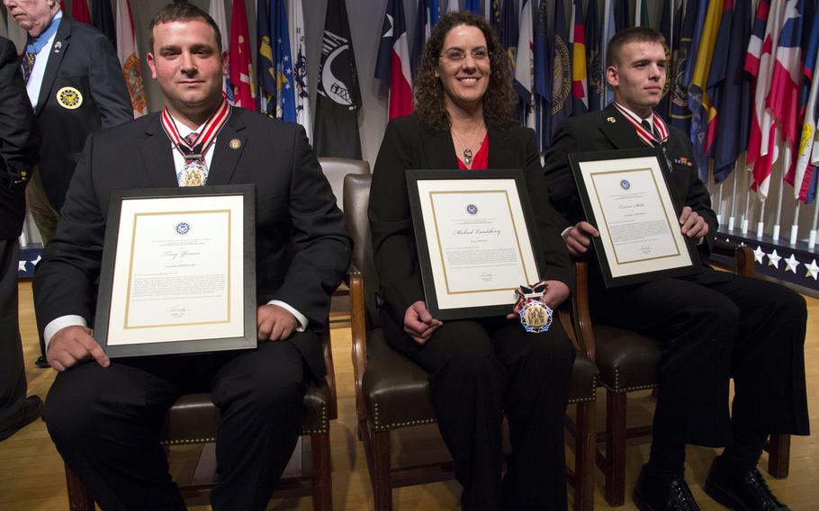 Citizen Honors award recipients Troy Yocum, Sharon Landsberry (on behalf of her late husband, Michael) and Connor Stotts pose for a photo after a ceremony at Arlington National Cemetery on Medal of Honor Day, March 25, 2014.