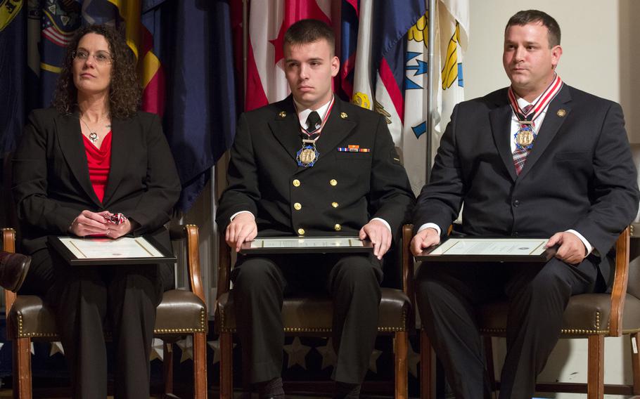 Citizen Honors award recipients Sharon Landsberry (who accepted for her late husband, Michael), Connor Stotts and Troy Yocum, during a ceremony at Arlington National Cemetery on Medal of Honor Day, March 25, 2014.