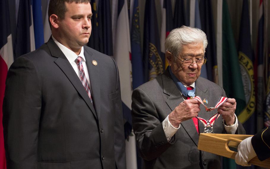 Medal of Honor recipient Hiroshi Miyamura prepares to present the Citizen Honors award to Troy Yocum during a ceremony at Arlington National Cemetery on Medal of Honor Day, March 25, 2014.