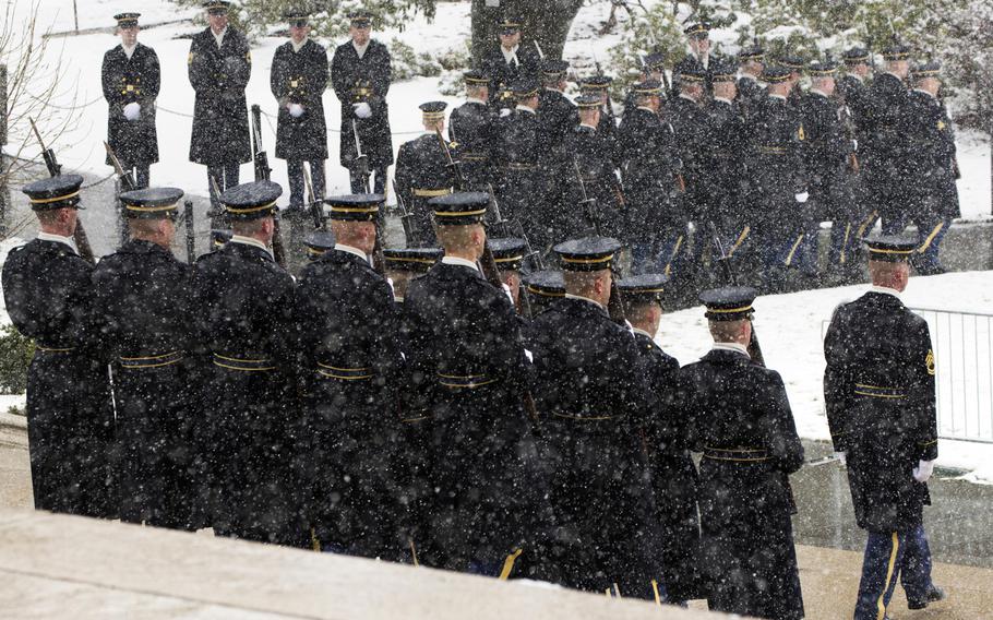 The honor guard leaves the Tomb of the Unknowns after a wreath-laying ceremony at Arlington National Cemetery on Medal of Honor Day, March 25, 2014.