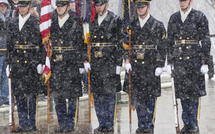 The color guard stands in he snow during the wreath-laying ceremony at Arlington National Cemetery on Medal of Honor Day, March 25, 2014.