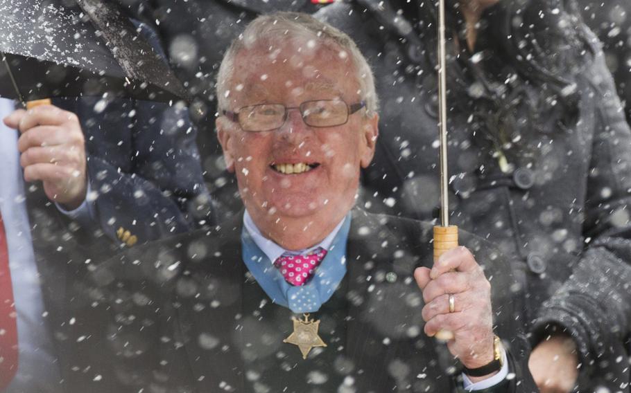 Medal of Honor recipient Thomas Kelley, a New Englander, seems unfazed by the falling snow during a wreath-laying ceremony at Arlington National Cemetery on Medal of Honor Day, March 25, 2014.