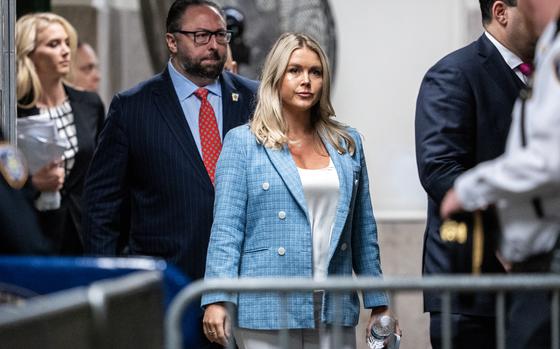 Trump campaign press secretary Karoline Leavitt, middle, and Trump adviser Jason Miller, left, arrive at the criminal trial of former President Donald Trump at Manhattan Criminal Court in New York on May 29, 2024. 