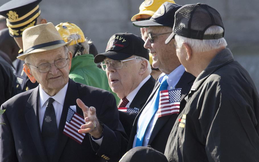 Harry Miller, left, talks with other World War II veterans during a Veterans Day ceremony at the National World War II Memorial in Washington, D.C., Nov. 11, 2016.