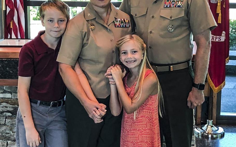 Marine Cols. Amy and Curtis Ebitz pose for a picture with their children, Curtis, 12, and Sevina, 8. Amy Ebitz is taking command of Headquarters and Support Battalion, Marine Corps Installations East at Camp Lejeune, N.C. and Curtis Ebitz is taking command of nearby Marine Corps Air Station New River.