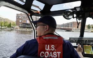 Boson's mate second class Tyler Boon navigates a U.S. Coast Guard small response boat down the Milwaukee River toward the RNC security zone on Wednesday, July 17, 2024 in Milwaukee, Wis. 