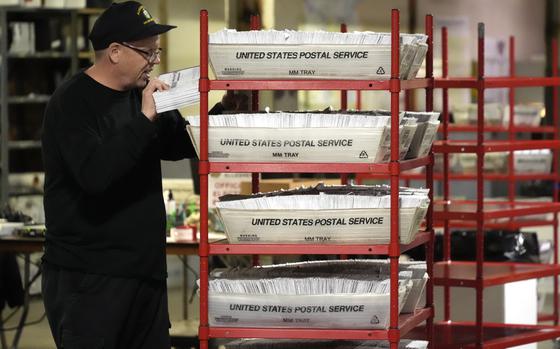 An Allegheny County worker processes mail-in and absentee ballots in Pittsburgh, April 18, 2024. 