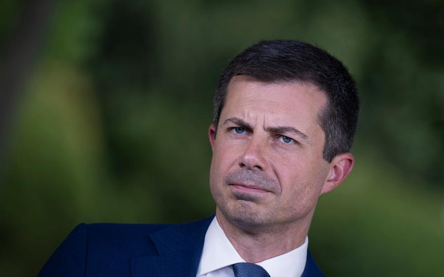 U.S. Transportation Secretary Pete Buttigieg listens during an interview in front of the White House July 23, 2024, in Washington, D.C.  The Biden administration proposed a rule on Thursday, Aug. 1, 2024, that would prevent airlines from charging extra for families with young children to sit near each other in a push to crack down on so-called junk fees. 