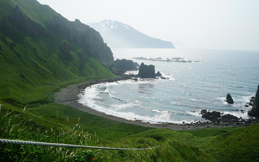 A rope is mounted cliffside at Horseshoe Bay that assists climbers in descending to the shore and nearby hot springs below on Adak Island, Alaska. 