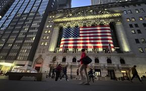 People pass the New York Stock Exchange on Nov. 5, 2024, in New York. 