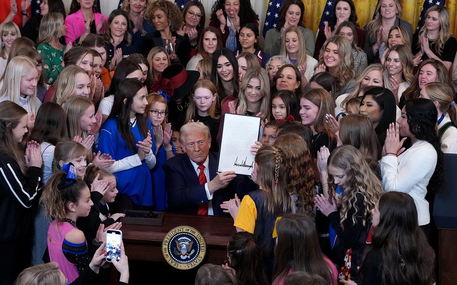 The U.S. president is joined by women and girls during a meeting.