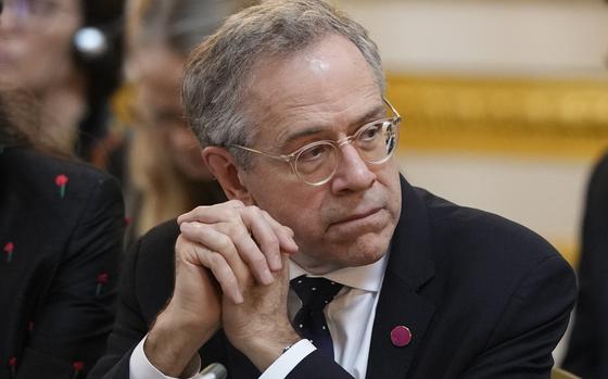 A U.S. government official listens during a meeting in London.