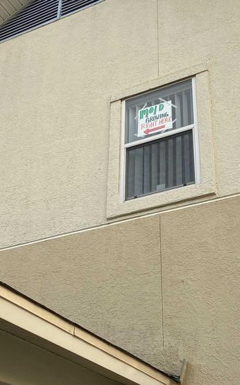 Courtney Hamilton hung a sign in her window to point to mold found last week in her house on base at Fort Hood, Texas. She was told in January that the house had been cleared of mold, and the Hamiltons are now one of nine families to file a lawsuit Monday against Lendlease, the private company that manages housing at the base. 