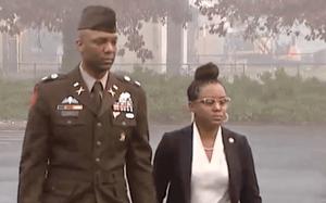 An Army soldier and his wife arrives at a courthouse.