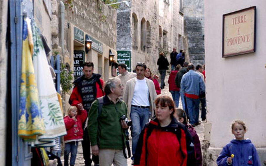 Visitors wander the narrow, cobblestone lanes of Les Baux. The village is popular with tourists year round, but is especially jammed in the summer.