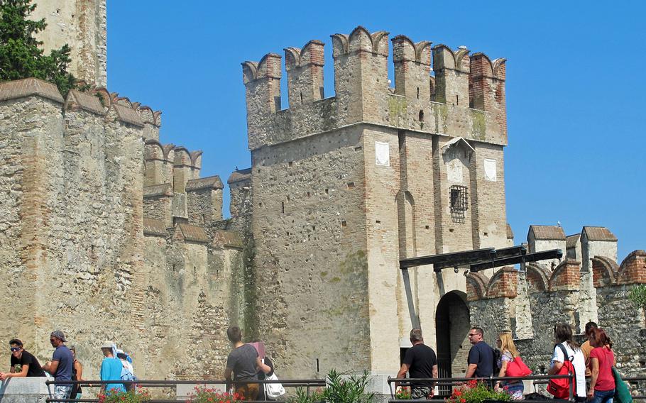 The entrance to Sirmione's historic town center is over a moat attached to a medieval fortress. Sirmione is a peninsular town on Italy's Lake Garda, not far from Vicenza.