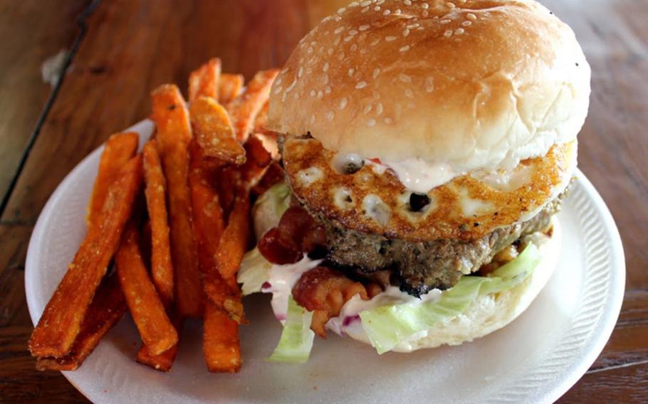 The rancheru burger at Meskla Dos includes egg, bacon and a spicy ranch sauce. If you don't want it meduim-well, let them know.