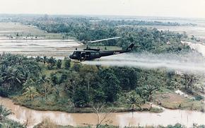 A U.S. Huey helicopter sprays Agent Orange over Vietnam.